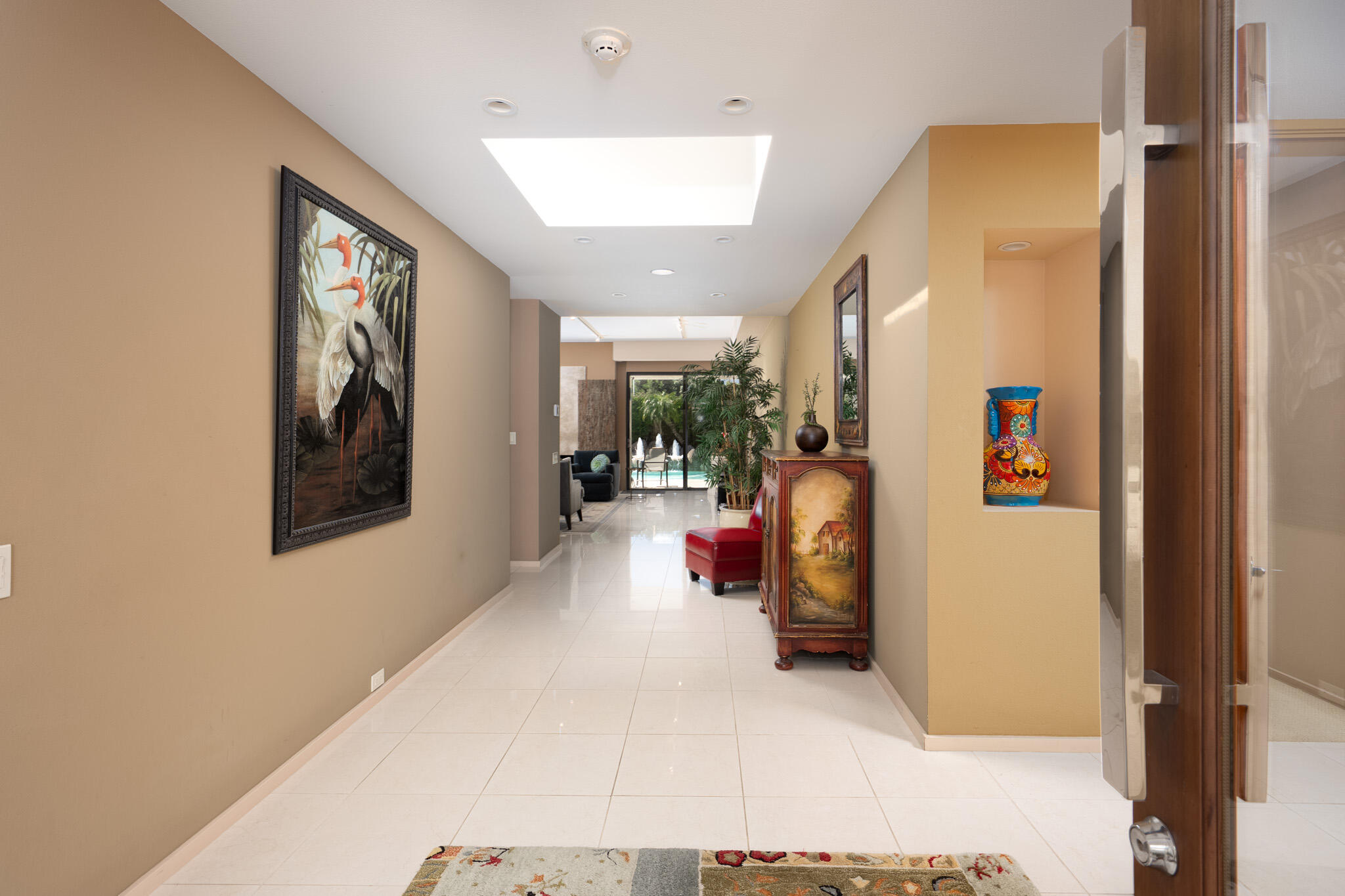 52 Princeton Drive Rancho Mirage, CA 92270 - Photo 4 of 52 a view of a hallway with paintings on the wall
