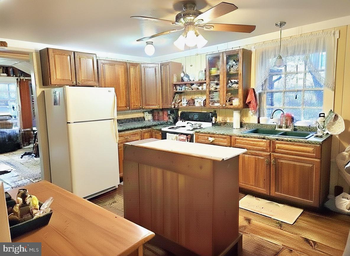 27329 Iron Gate Road Federalsburg, MD 21632 - Photo 24 of 57 a kitchen with a refrigerator a stove a sink and a dining table