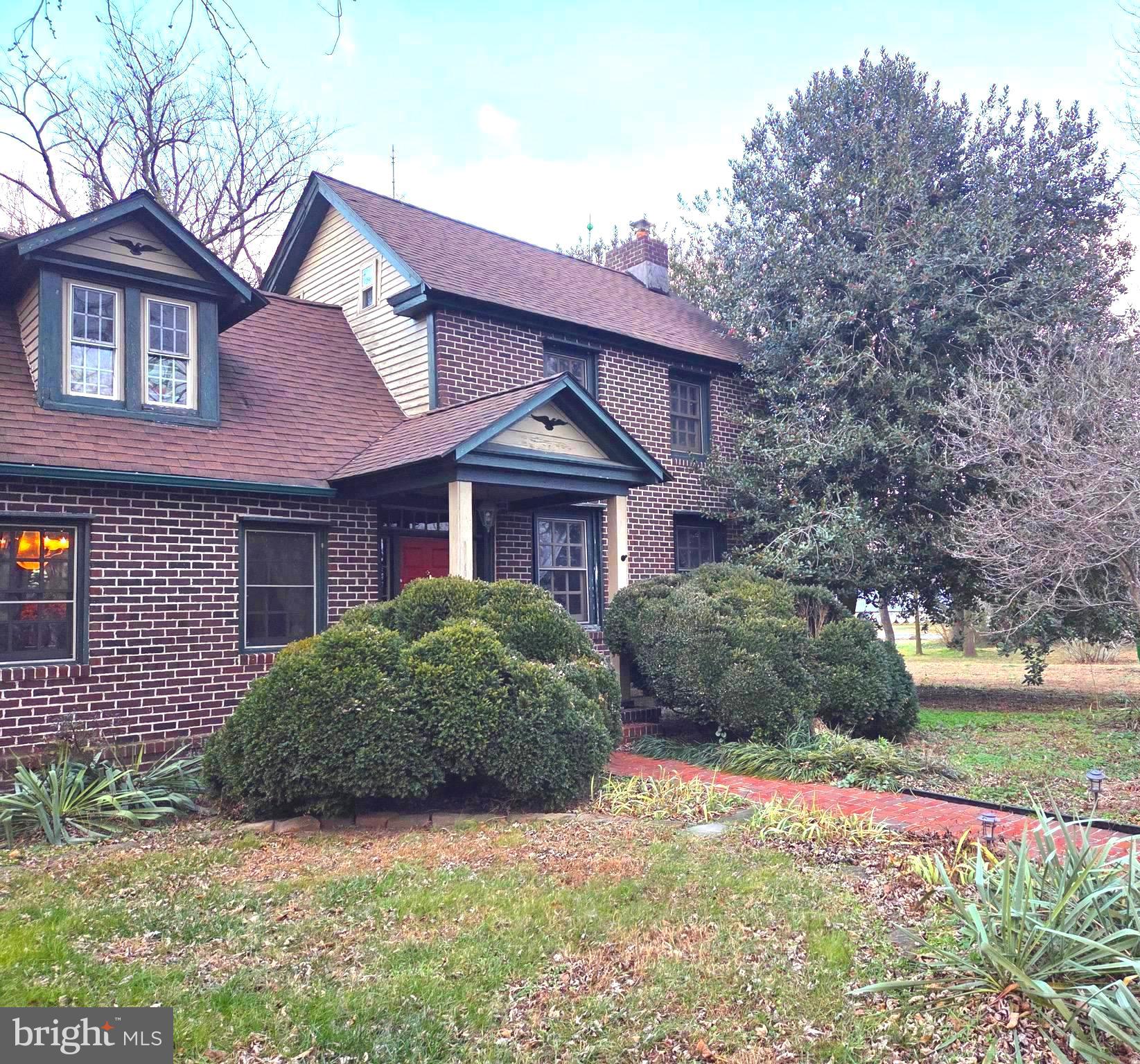 27329 Iron Gate Road Federalsburg, MD 21632 - Photo 3 of 57 a view of a brick house with a big yard and large trees