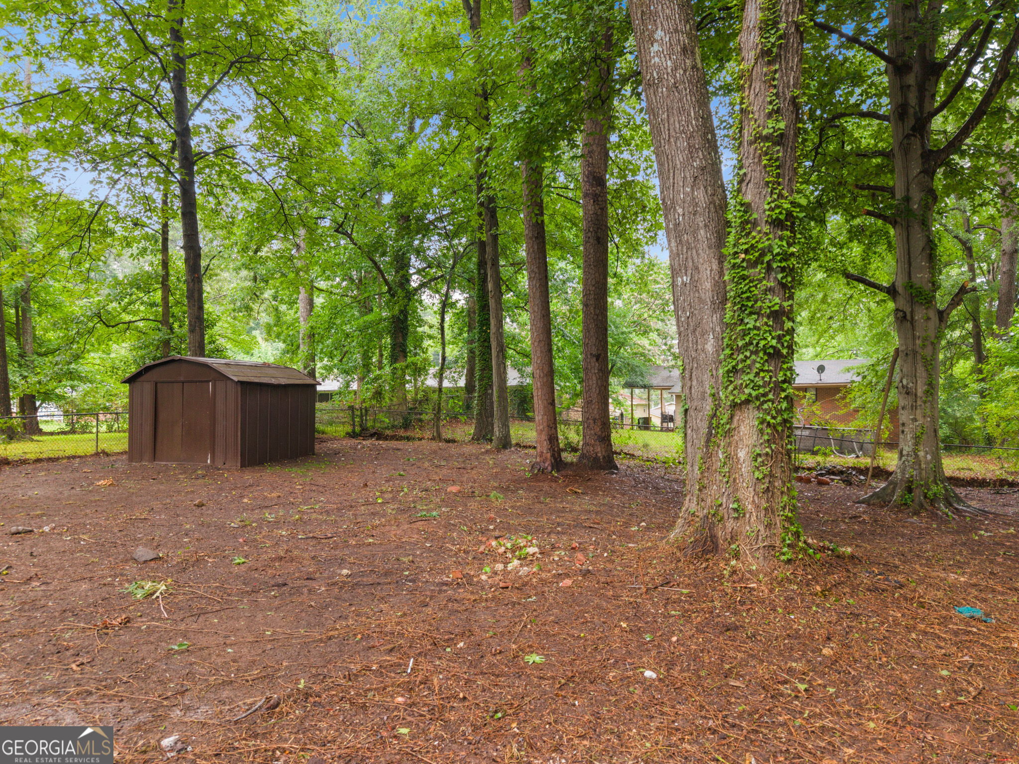 3567 Forrest Park Road Southeast Atlanta, GA 30354 - Photo 26 of 29 a view of a house with large trees and a small barn