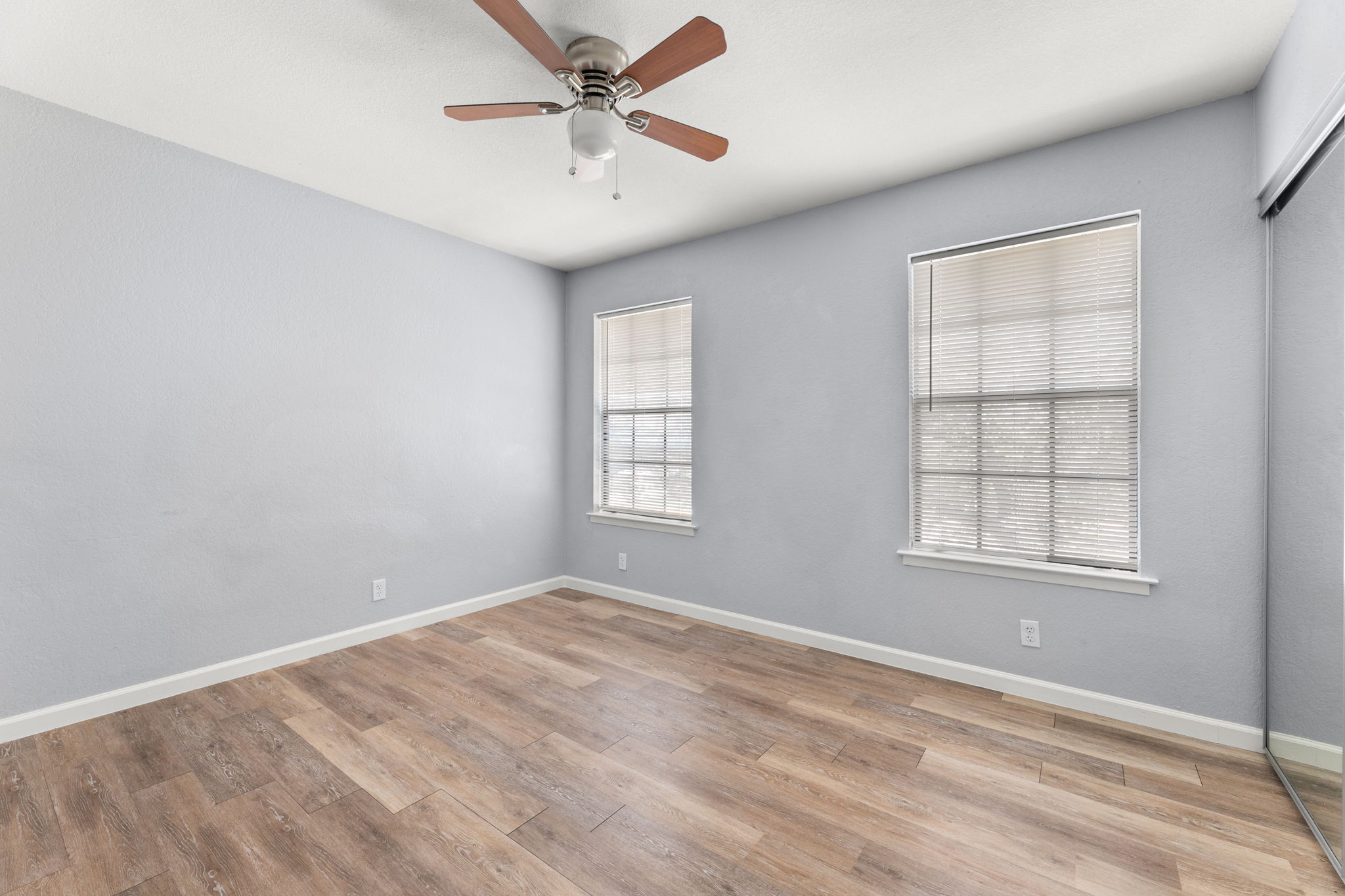 3802 Foust Trail, Unit A Georgetown, TX 78628 - Photo 28 of 34 Well-lit sleeping quarters with wood-look flooring and ample natural light.