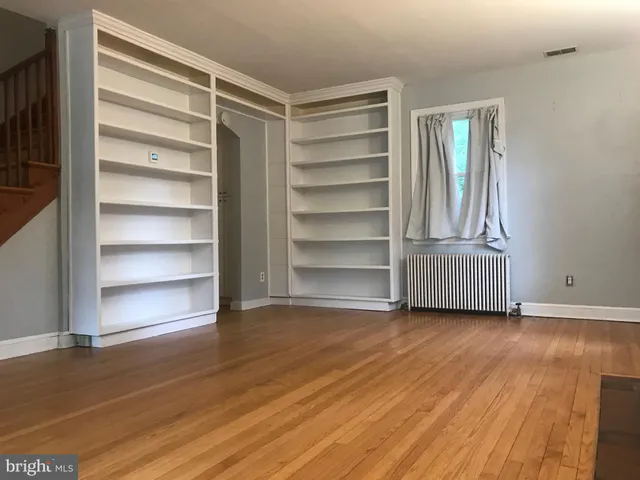a view of a room with wooden floor and closet