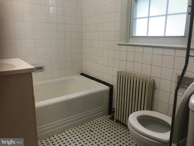 a bathroom with a sink a toilet and a bathtub