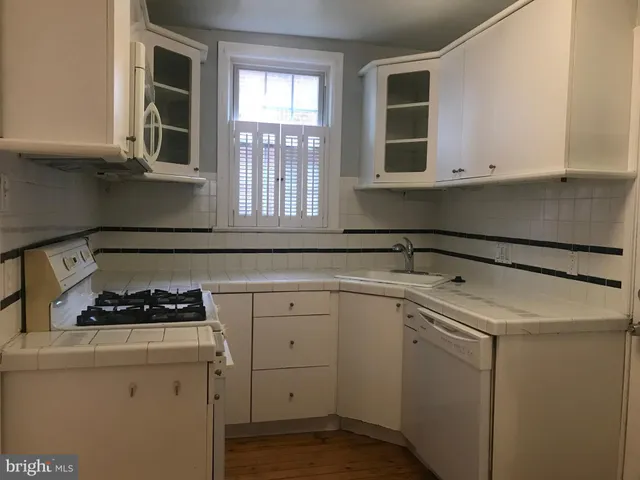 a kitchen with cabinets and window