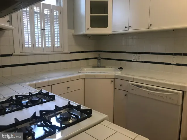 a kitchen with a stove and a cabinets