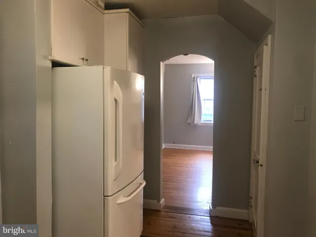 a view of hallway with wooden floor