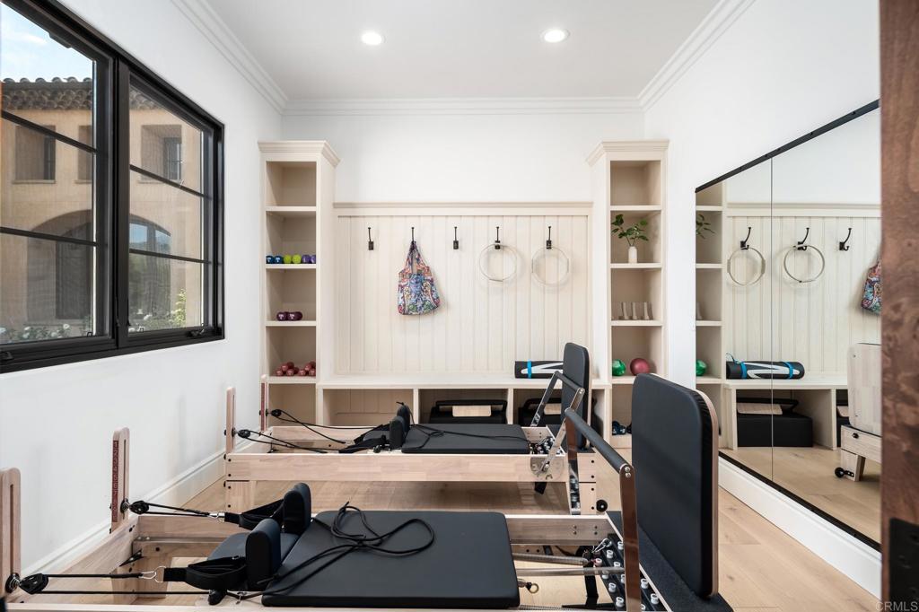18000 Sunset Point Road Poway, CA 92064 - Photo 22 of 36 a room with furniture a large window and gym equipment