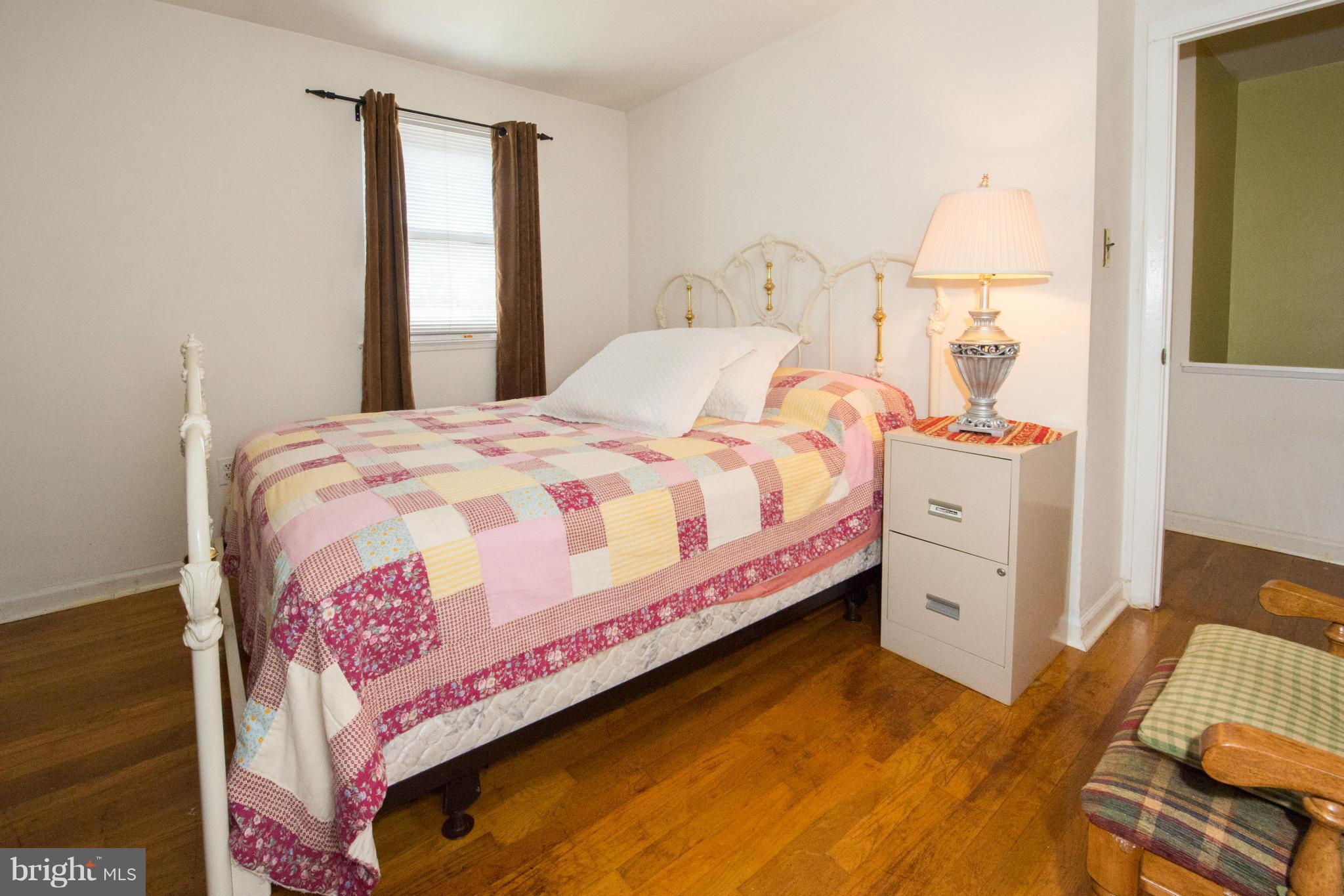 4738 Vancouver Road Baltimore, MD 21229 - Photo 12 of 30 a bedroom with a bed and a dresser