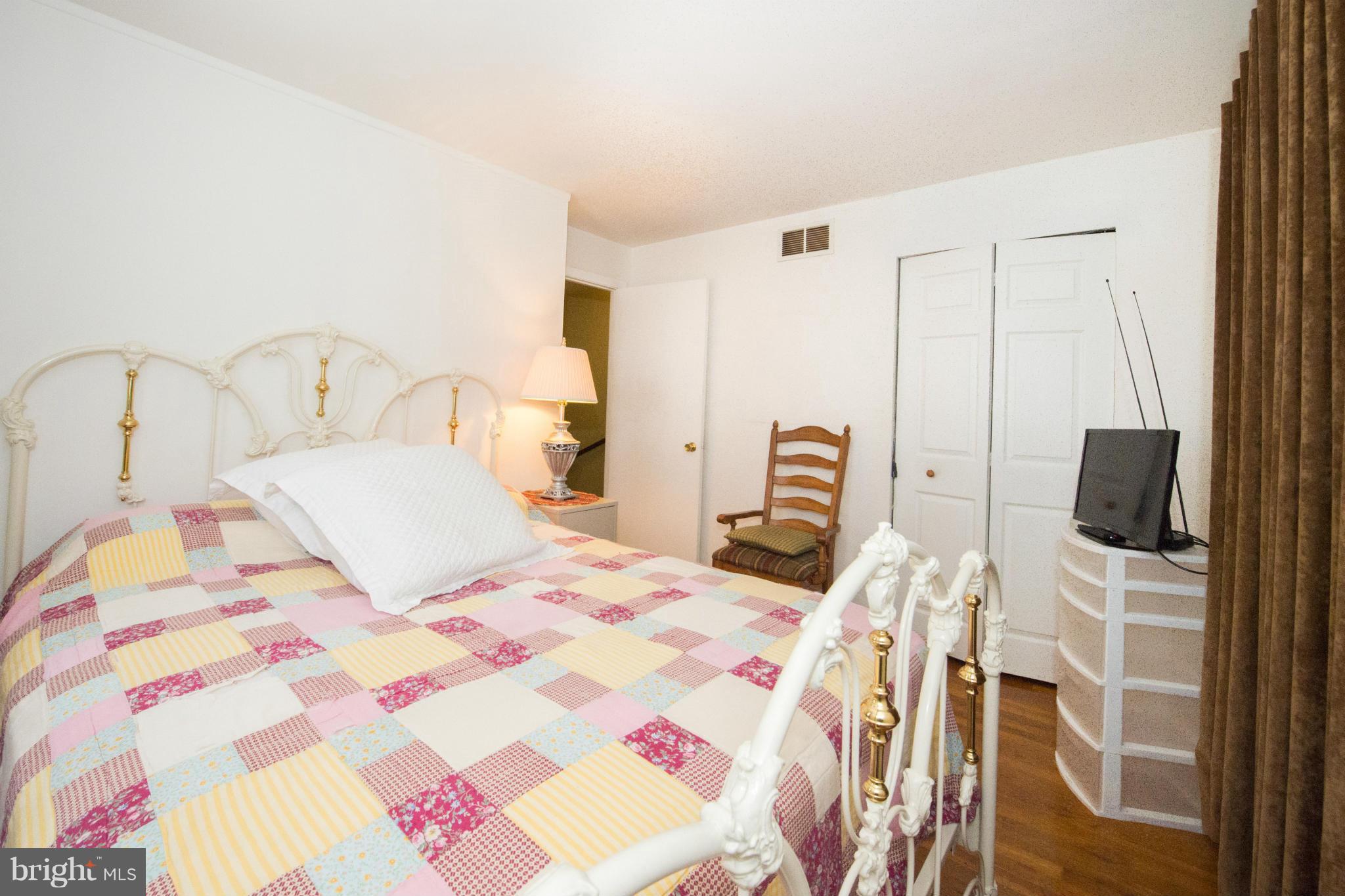 4738 Vancouver Road Baltimore, MD 21229 - Photo 13 of 30 a bedroom with a bed and a flat screen tv