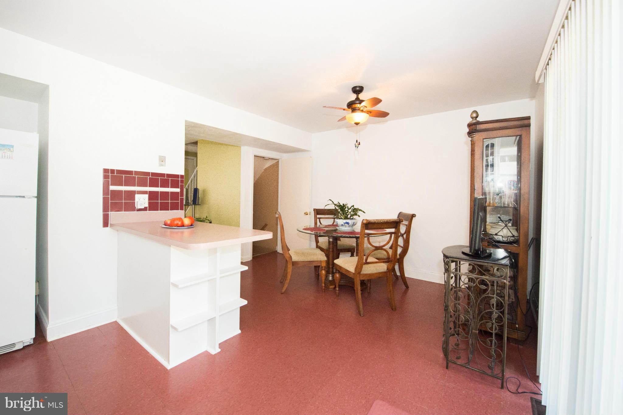 4738 Vancouver Road Baltimore, MD 21229 - Photo 17 of 30 a dining room with furniture and a chandelier