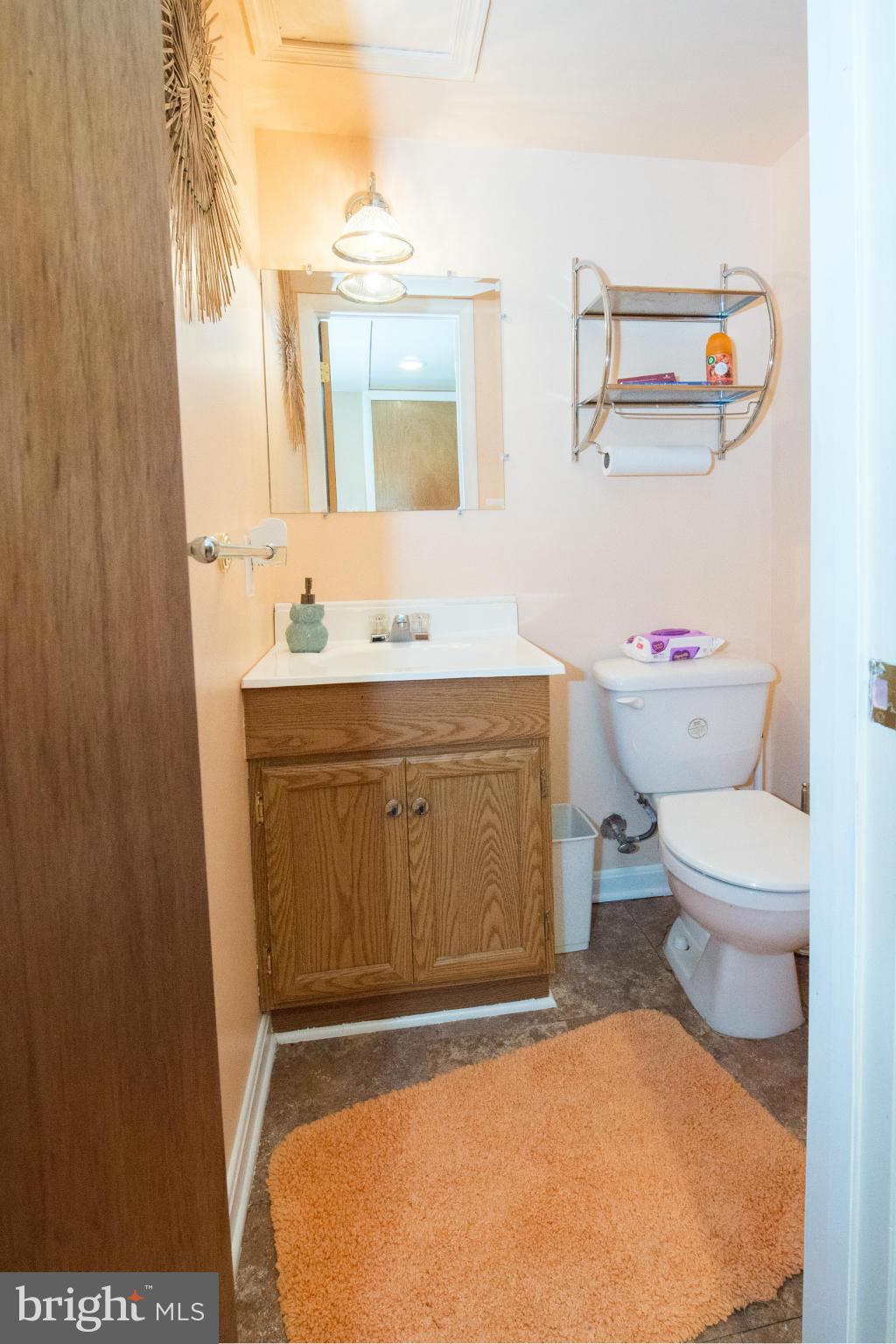 4738 Vancouver Road Baltimore, MD 21229 - Photo 25 of 30 a bathroom with a toilet sink and mirror