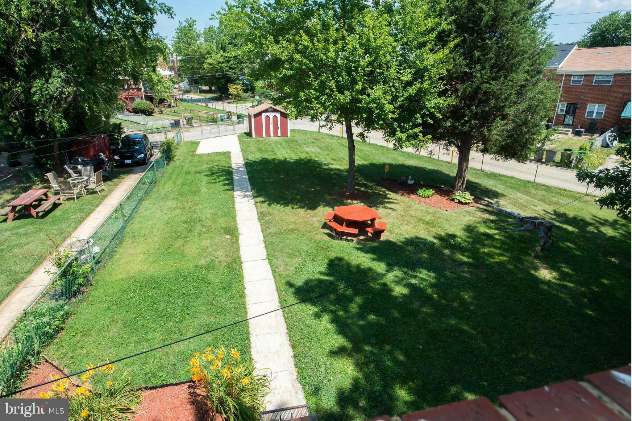 4738 Vancouver Road Baltimore, MD 21229 - Photo 5 of 30 a view of a backyard with a garden and trees