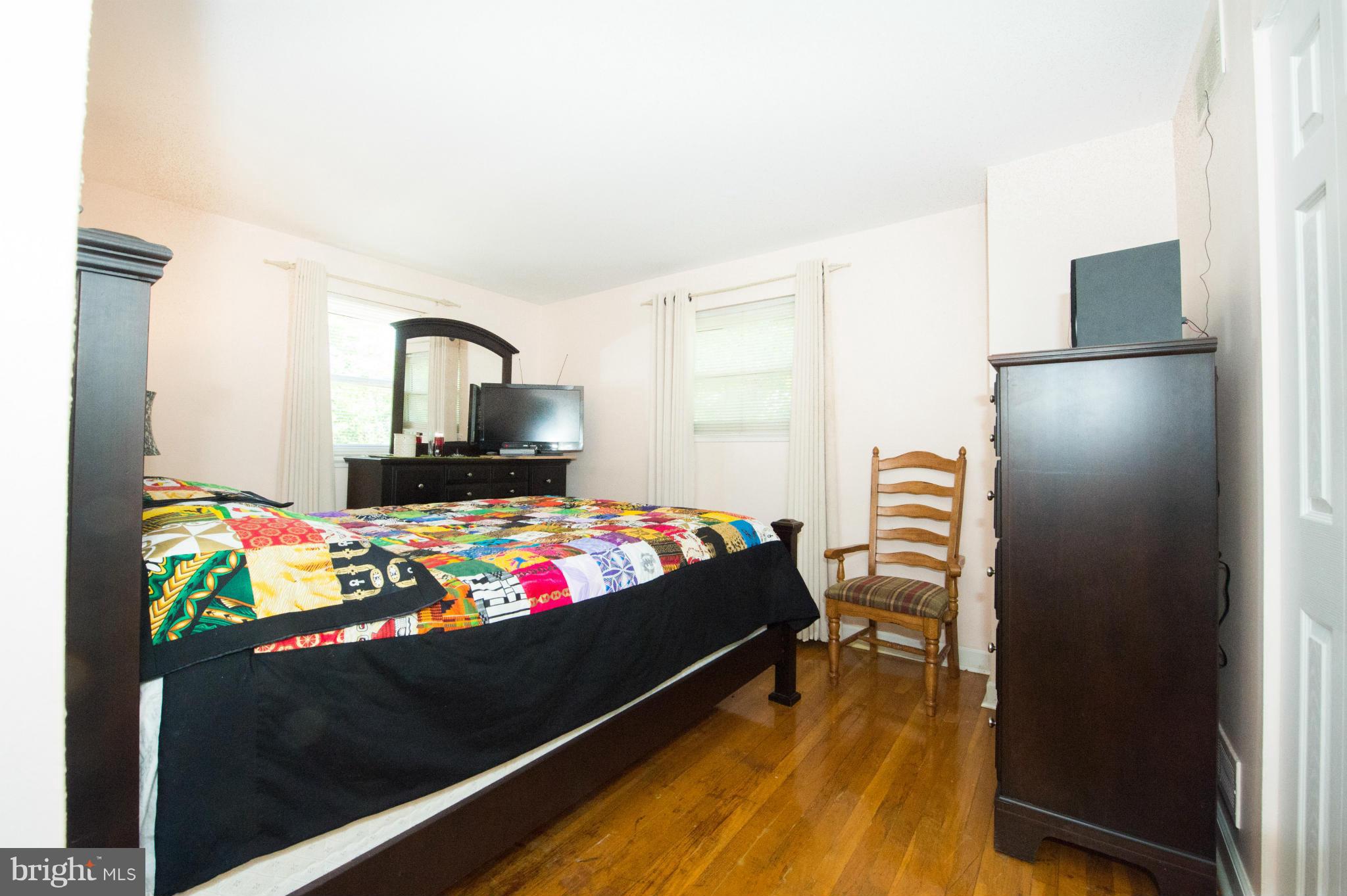 4738 Vancouver Road Baltimore, MD 21229 - Photo 6 of 30 a bedroom with a bed and dresser with mirror