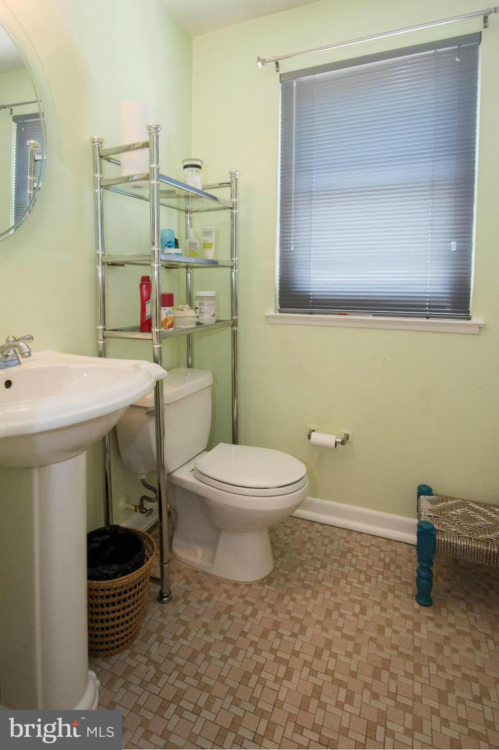 4738 Vancouver Road Baltimore, MD 21229 - Photo 8 of 30 a bathroom with a toilet sink and mirror