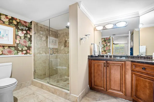 a bathroom with a granite countertop sink mirror and shower
