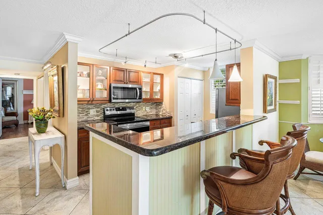 a kitchen with stainless steel appliances granite countertop a stove and a sink