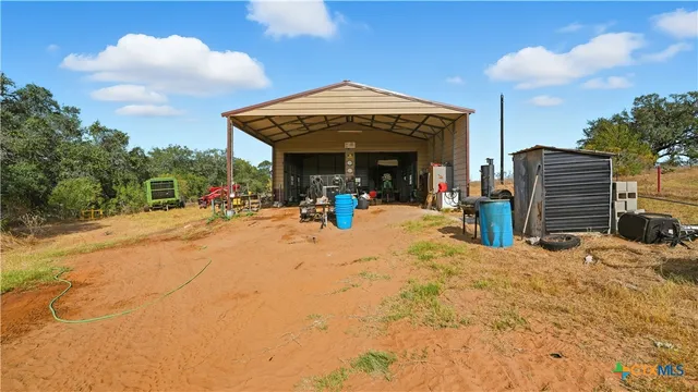 a view of a garage with a bike and white car