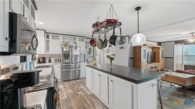 a view of a dining room with furniture large window and wooden floor