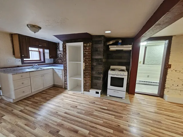 a view of a kitchen with a sink cabinets and a window