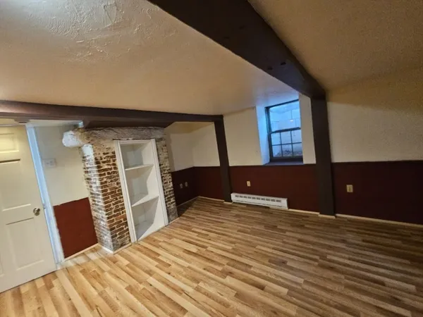a view of an empty room with a fireplace