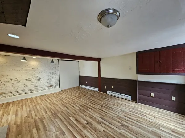 a view of a room with cabinet and mirror