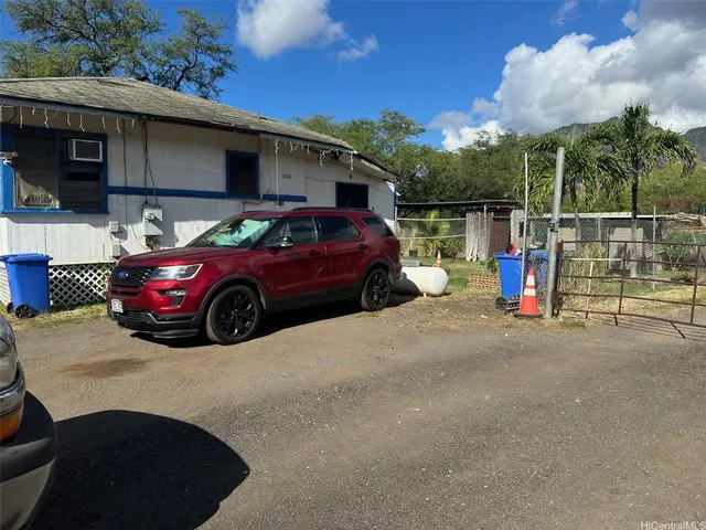 a view of a car parked in back of a house