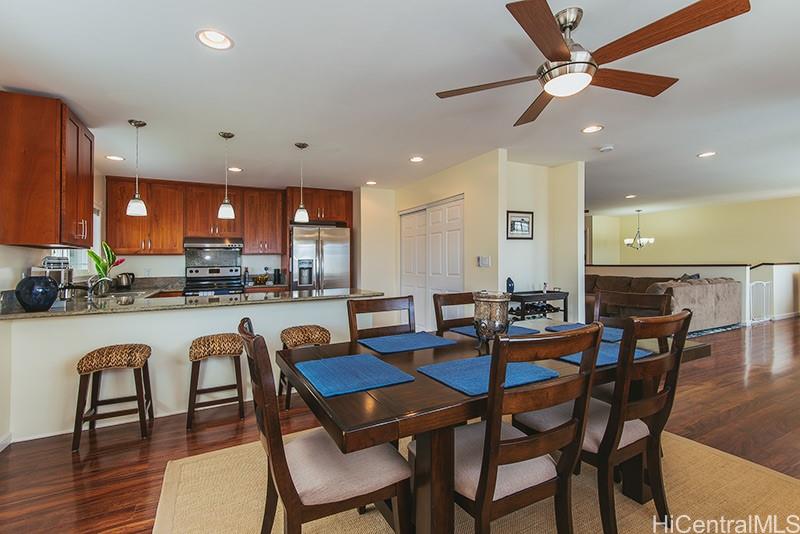 1381 Akalani Loop, Unit 1381A Kailua, HI 96734 - Photo 1 of 1 a dining room with stainless steel appliances furniture a dining table and chairs