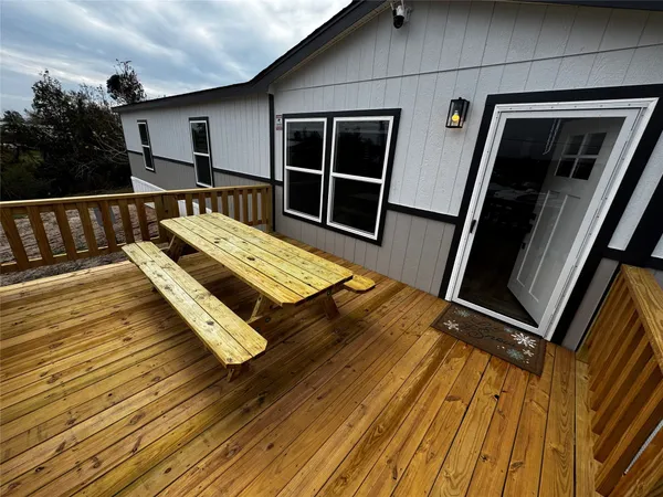 a view of balcony with wooden floor and furniture