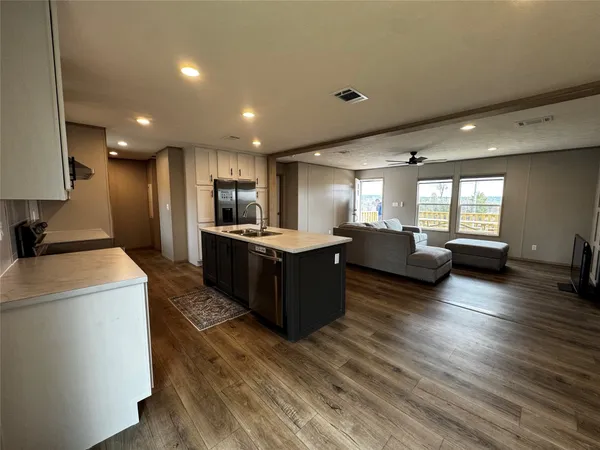 a living room with furniture and a wooden floor