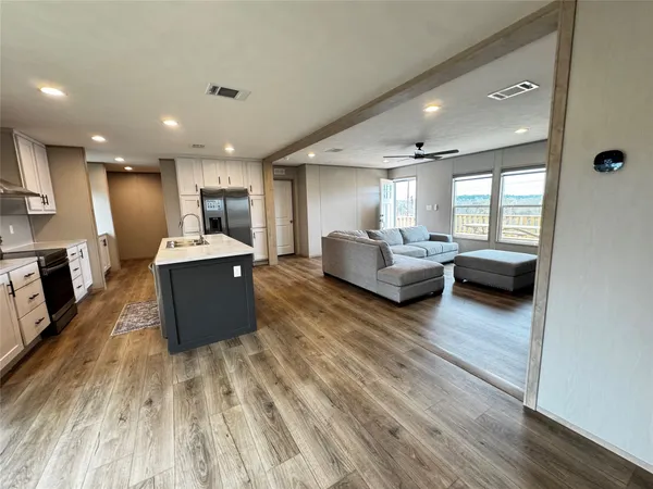 a living room with furniture and a wooden floor