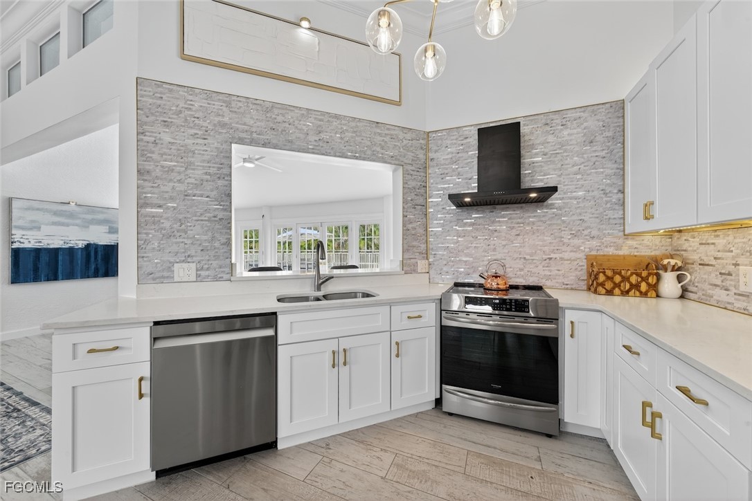 13570 Harbour Ridge Drive Fort Myers, FL 33908 - Photo 16 of 50 a kitchen with white cabinets and appliances