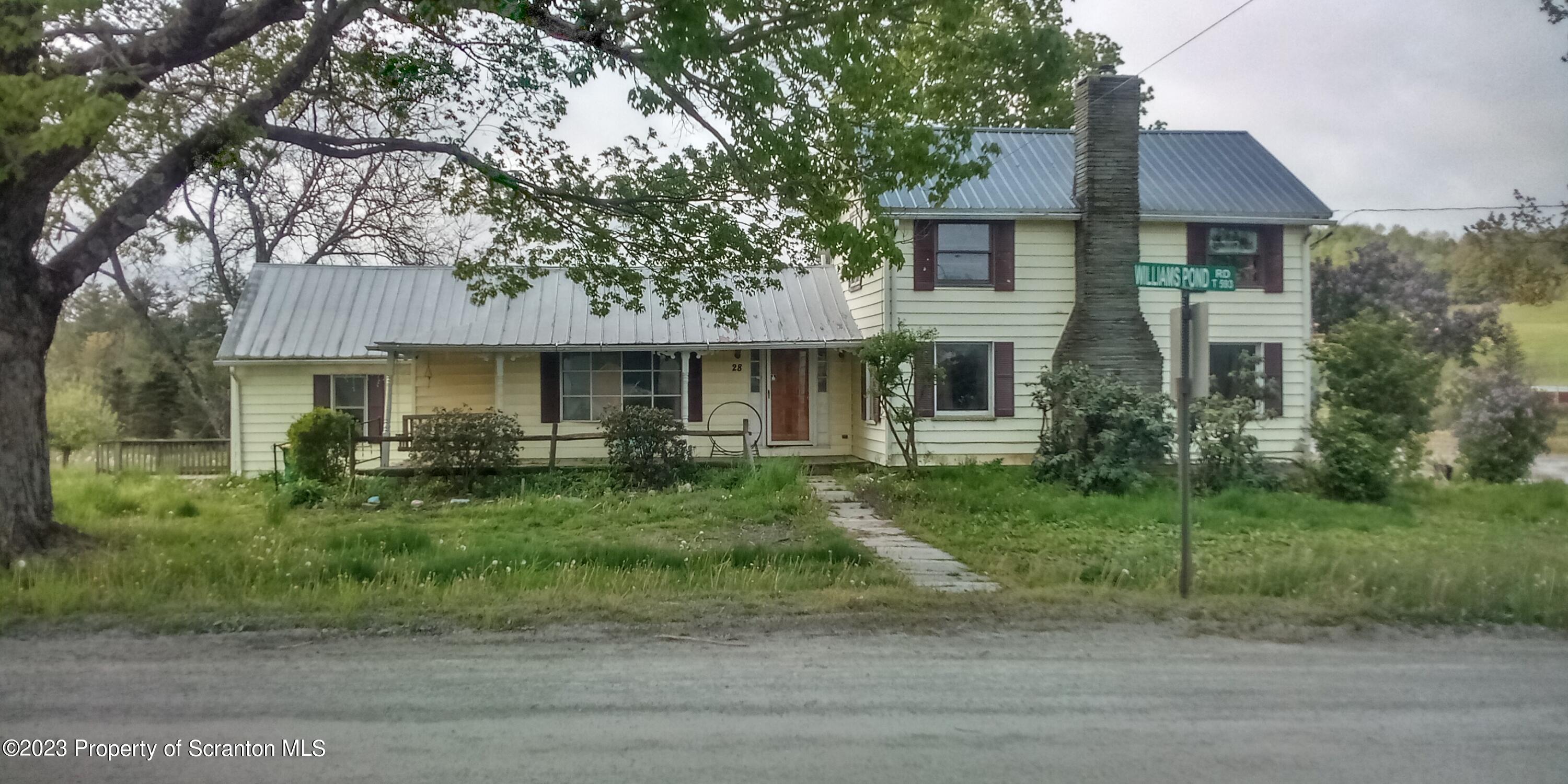 28 Williams Pond Road Montrose, PA 18801 - Photo 1 of 38 a front view of a house with a yard