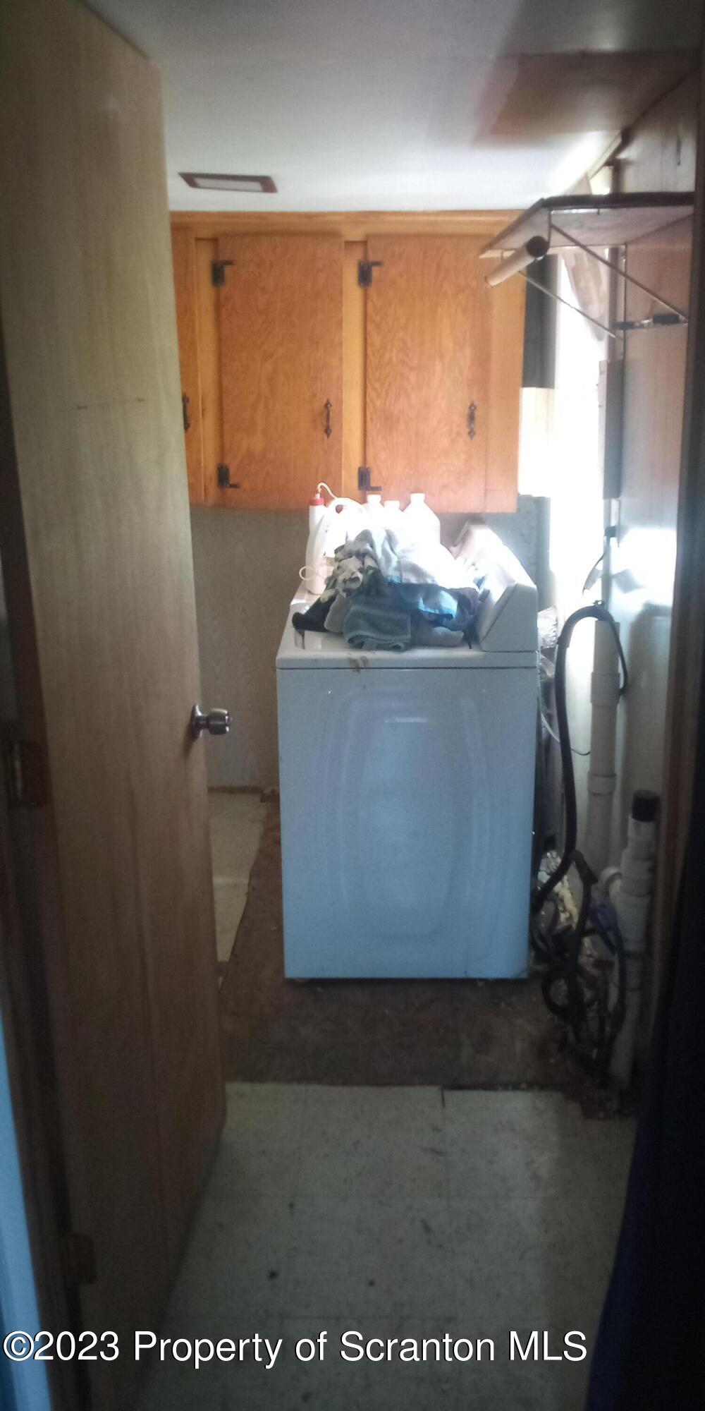 28 Williams Pond Road Montrose, PA 18801 - Photo 18 of 38 a room with water heater and wooden cabinets