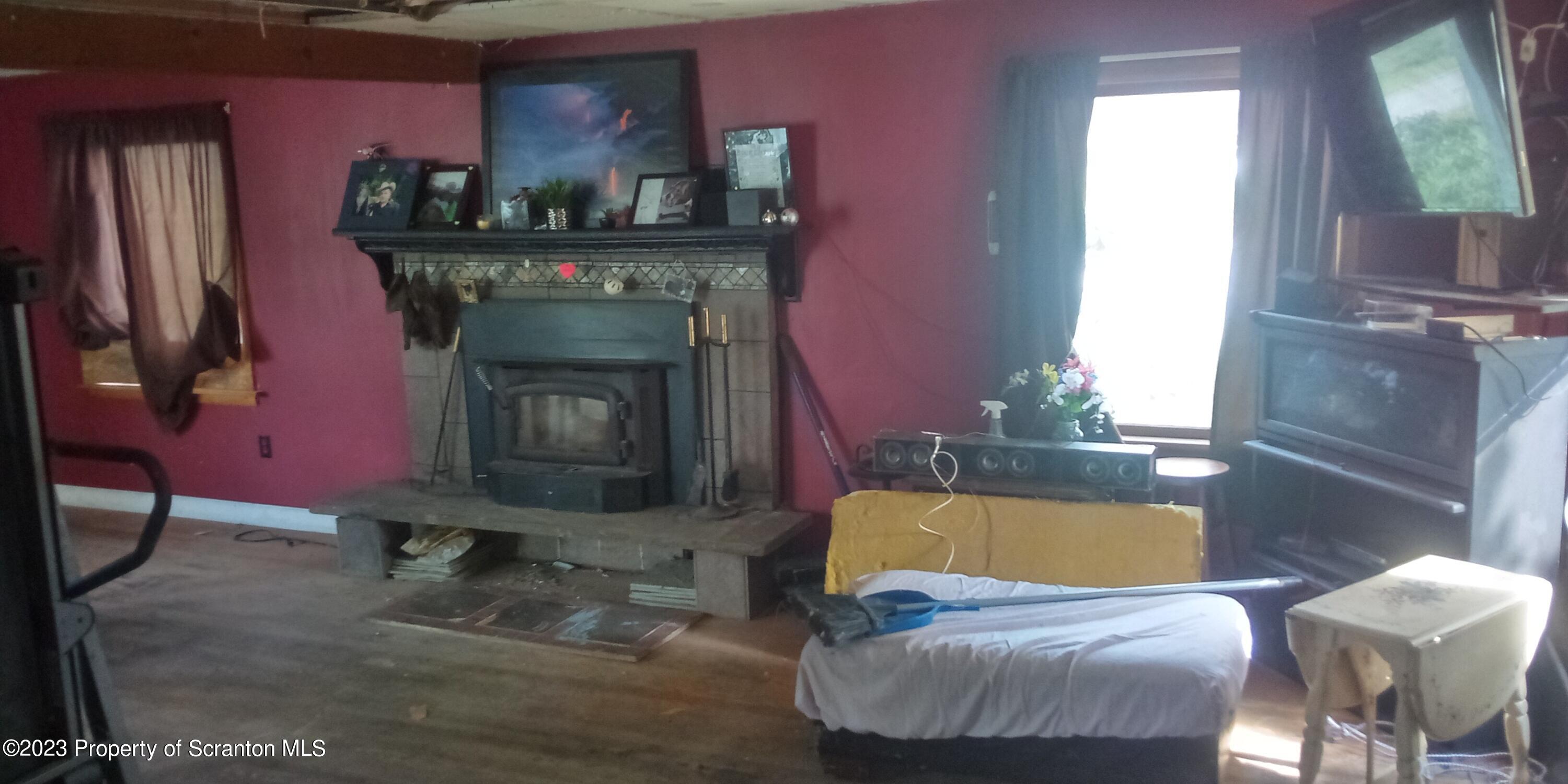 28 Williams Pond Road Montrose, PA 18801 - Photo 21 of 38 a living room with furniture and a fireplace