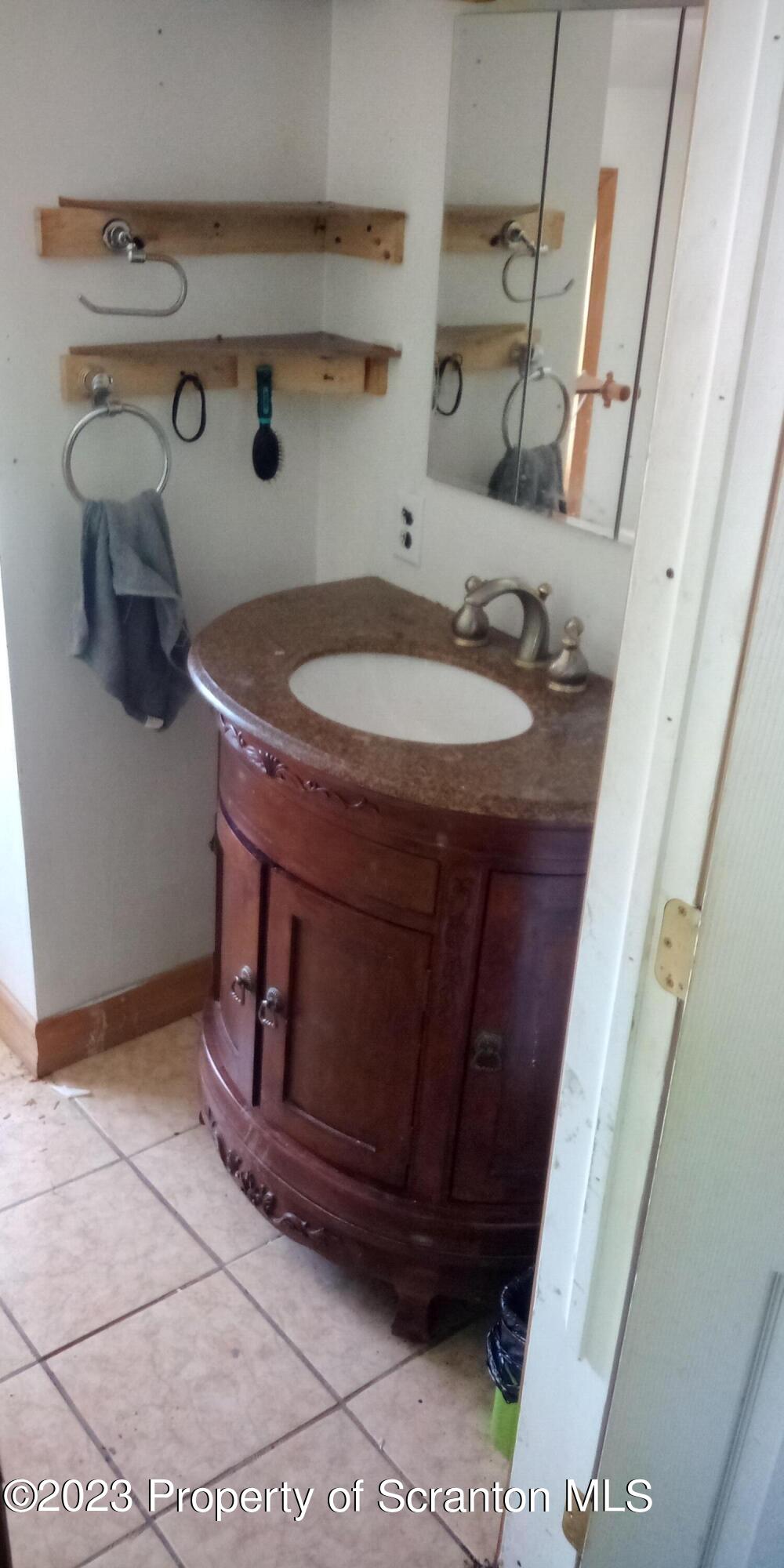 28 Williams Pond Road Montrose, PA 18801 - Photo 35 of 38 a bathroom with a sink and a mirror
