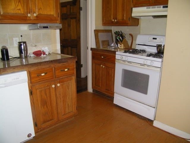 2984 Scheibler Road Memphis, TN 38128 - Photo 8 of 13 a kitchen with stainless steel appliances granite countertop a stove a microwave and cabinets