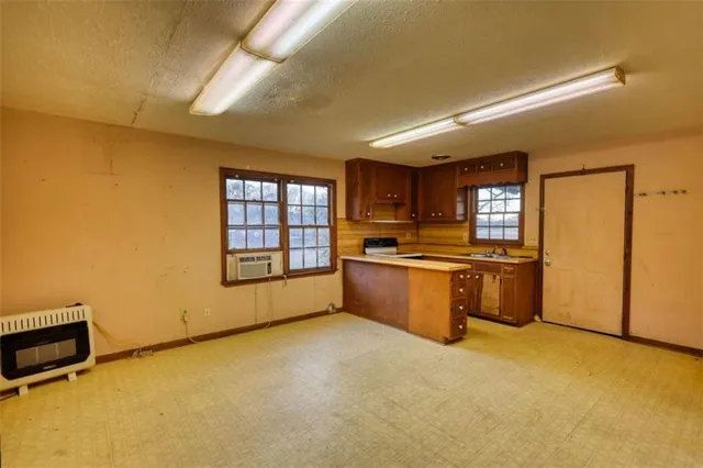 a view of a kitchen with a sink and cabinets