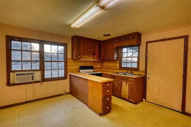 a kitchen that has a sink and a large window