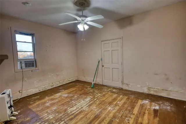 a view of a livingroom with a ceiling fan and window