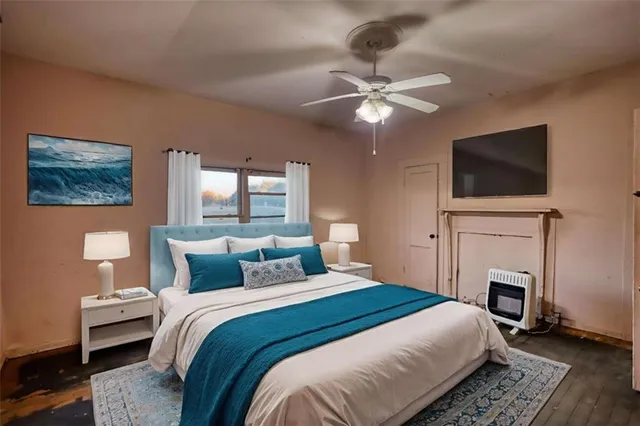 an empty room with windows and fireplace