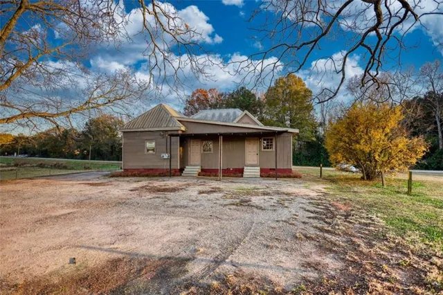 a front view of a house with a yard and trees
