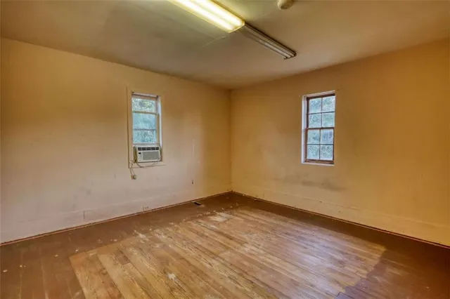 a view of a room with wooden floor and a window