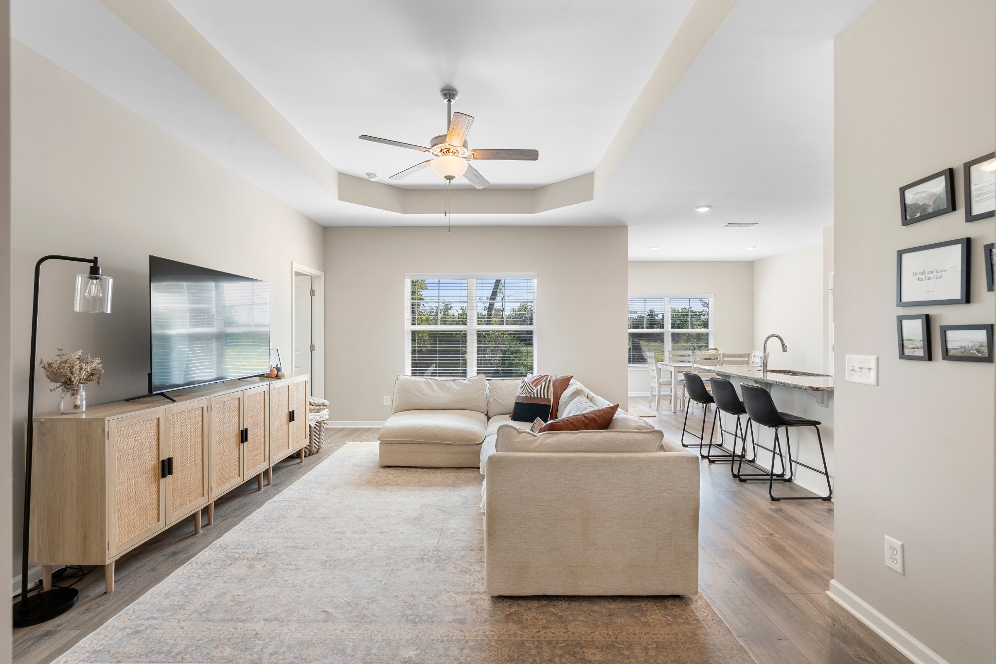 a living room with furniture fireplace and wooden floor
