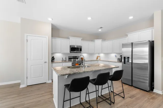 a kitchen with kitchen island granite countertop a center island stainless steel appliances cabinets and a counter top space