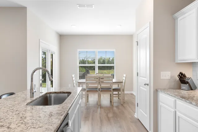 a kitchen with a refrigerator and a sink