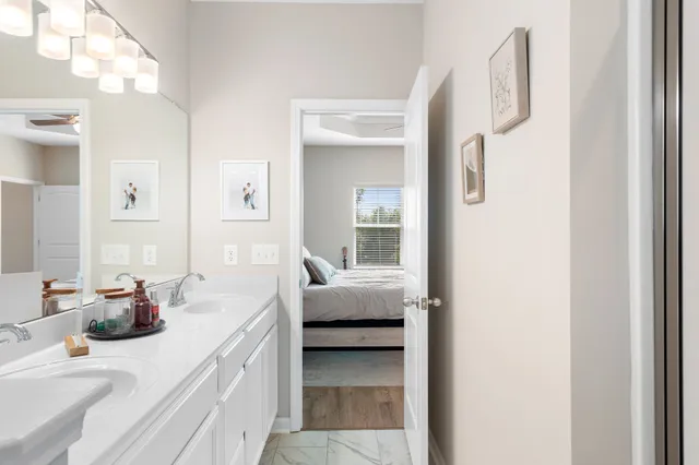 a en suite bathroom with a double vanity sink and a mirror