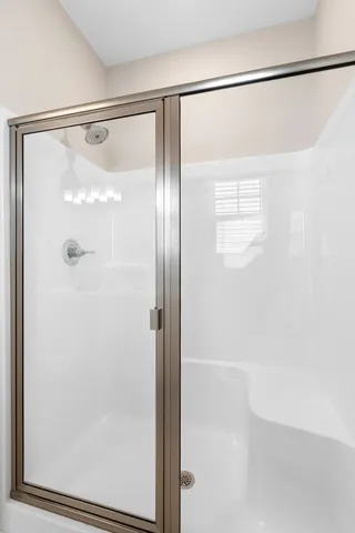 a bathroom with a glass shower door