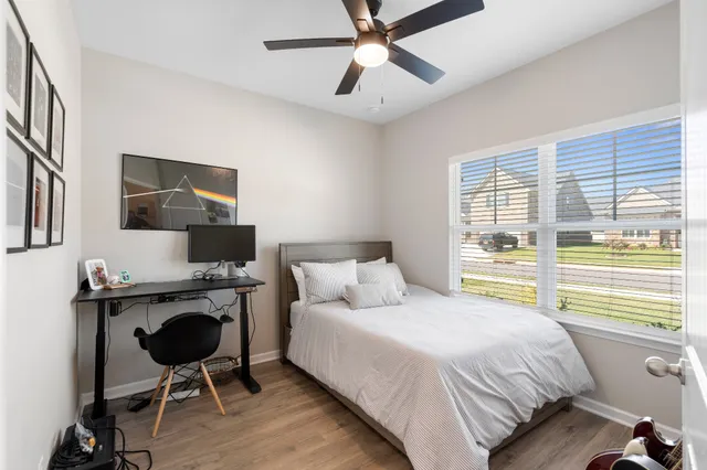 a bedroom with a bed window and a desk