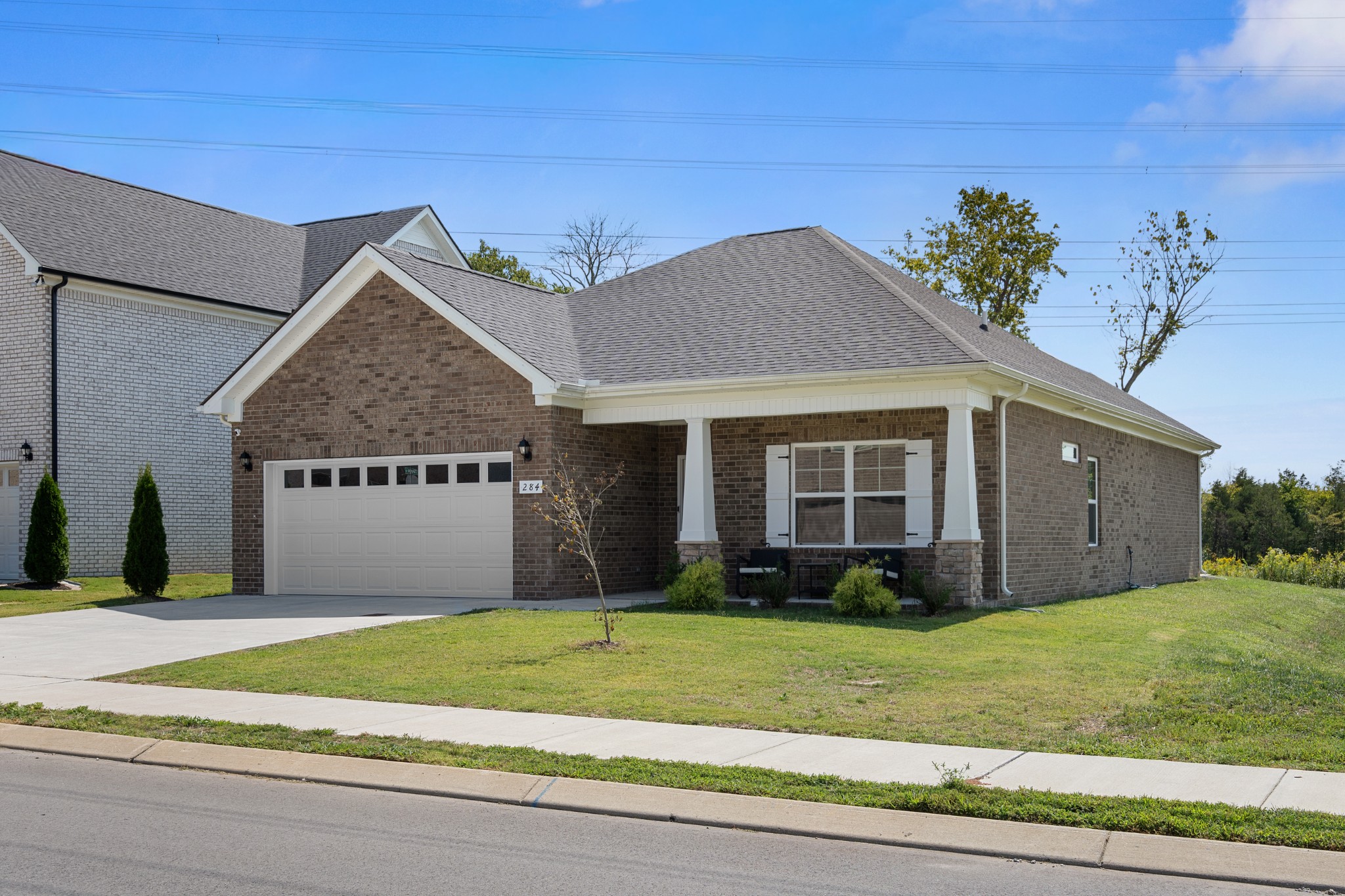 284 Thorpe Drive Spring Hill, TN 37174 - Photo 4 of 34 a front view of a house with a yard and potted plants