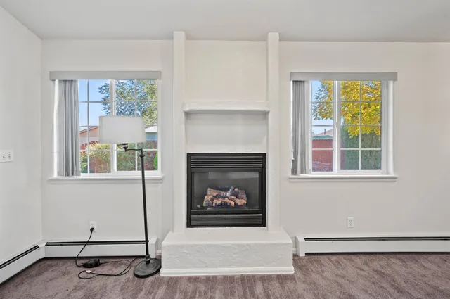 a living room with a fireplace and a window